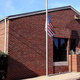 Image for article titled Flag In Front Of Post Office Can Hardly Remember A Time It Wasn't Flying Half-Staff
